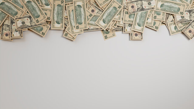 Ten Dollar Bills Border on White Surface. Banking Wallpaper with copy-space.