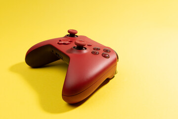 red game controller isolated on yellow background © TropicalNinjaStudio