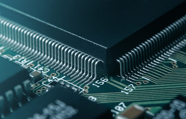 Macro photo of application specific integradet circuit in QFP package mounted on printed circuit board