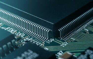 Macro photo of application specific integradet circuit in QFP package mounted on printed circuit...