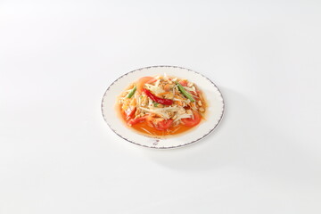 Papaya salad (Som Tam) in a white dish.