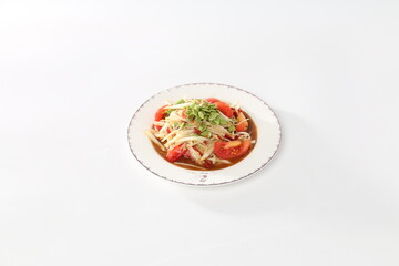 Papaya salad with pickled fish in a white dish.