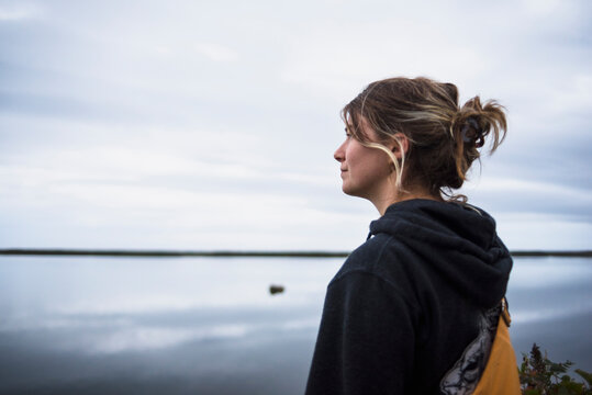 Young woman looking at view on seashore, Charlestown, Rhode Island, USA