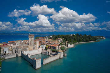 Aerial view on Sirmione sul Garda. Italy, Lombardy. Rocca Scaligera Castle in Sirmione. Aerial photography with drone. Tourist destination in Lombardy region of Italy.