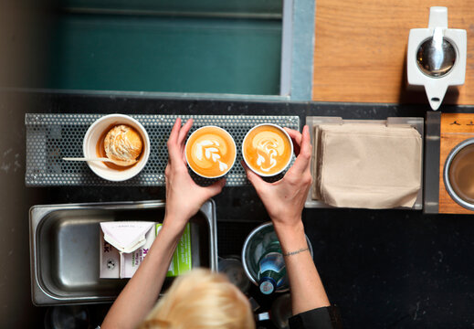 Preparing coffee with milk pattern, Oakland, USA
