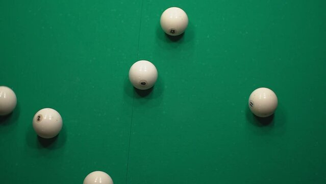 a man tries to correctly break a pyramid of white balls in Russian billiards. real time video. close-up. High-quality Full HD video recording.