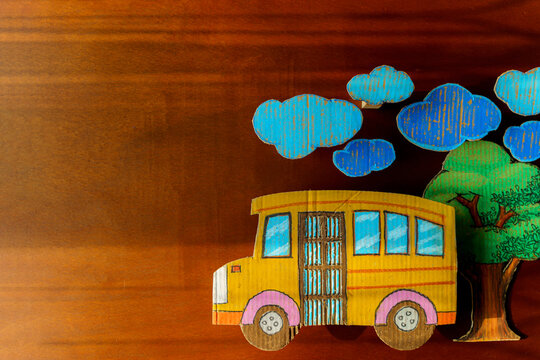 Education and back to school concept, pencils stand as bus on wooden table in classroom.