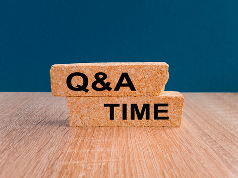 Q and A, questions and answers time symbol. Concept words 'Q and A time' on brick blocks on a wooden table, beautiful blue background. Business and Q and A time concept.