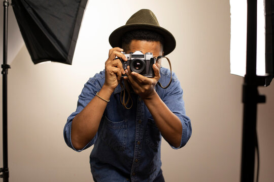 Man clicking photo using camera in studio