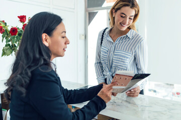 Receptionist showing flyer to customer