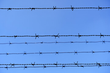 Fence with barbed wire. Border, prohibition, zone, emigration concept.