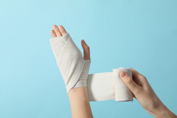 Concept of hand injury help with elastic bandage - obrazy, fototapety, plakaty