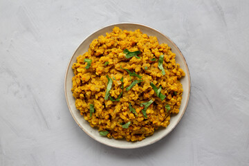 Homemade Red Lentil Dahl with Rice and Cilantro on a gray background, top view. Flat lay, overhead, from above.