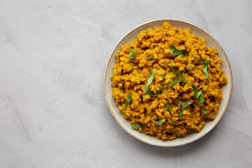 Homemade Red Lentil Dahl with Rice and Cilantro on a gray background, top view. Flat lay, overhead,...