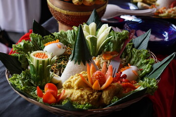 Nasi tumpeng (cone rice) served with urap-urap (Indonesian salad), fried chicken and noodles. Nasi tumpeng usually served at birthday parties or thanksgiving