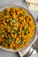 Homemade Red Lentil Dahl with Rice and Cilantro on a gray background, top view. Flat lay, overhead, from above.