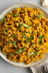 Homemade Red Lentil Dahl with Rice and Cilantro on a gray background, top view. Flat lay, overhead, from above.