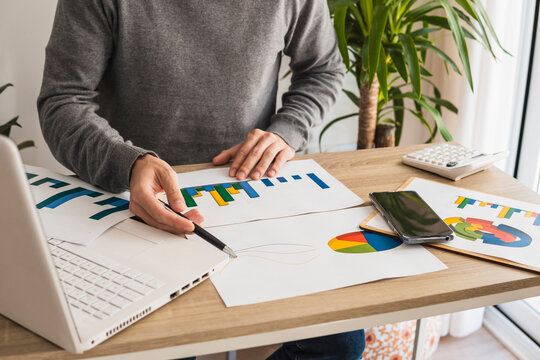 Businessman with graphs and pie charts working in office