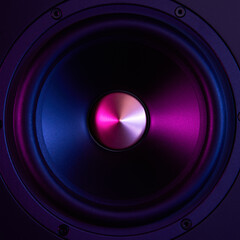 Sound speaker on dark background with neon lights. Set for listening music. Audio equipment