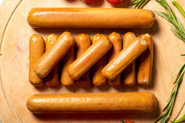 Beef sausage. Raw grilled sausages on a wood flipchart. Deli products. Top view