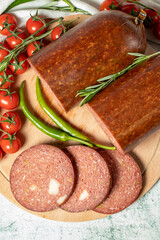 Beef sausage with cheddar. Raw grilled sausage on a wood serving board. Deli products. Top view