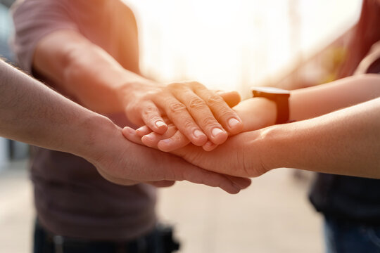 People joining hands in the middle.Successful multiracial businesspeople reach business goal feel happy stacked their hands together