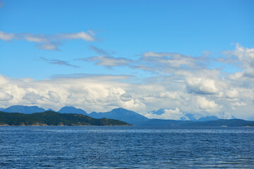 Blue sky with some couds in ocean bay in Canada near Vancouver.