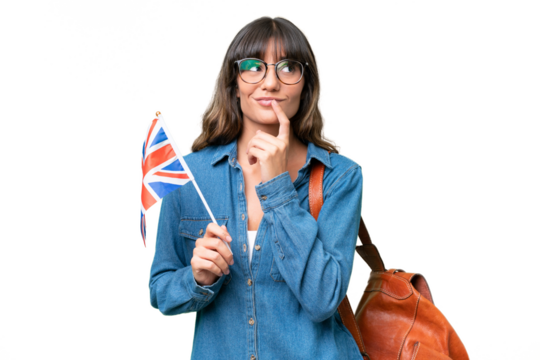 Young caucasian woman holding an United Kingdom flag over isolated background having doubts while looking up