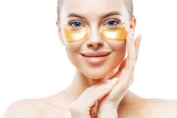 Close up shot of charming tender young woman applies gold collagen patches on fresh facial skin, touches face, has makeup, well cared body, stands against white background. Under eye treatment.