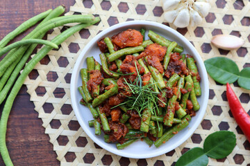 Thai Red curry stir fried green beans - Asian food, In Thai called Pad Prik King at top view on wood table