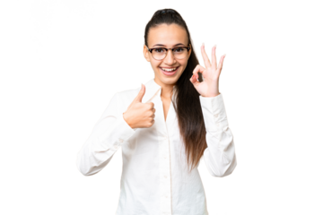 Young Arabian woman over isolated chroma key background showing ok sign and thumb up gesture