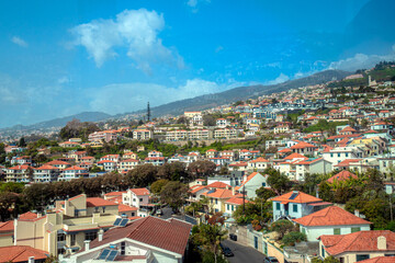 Fototapeta na wymiar aerial view of Funchal city from cablecar - teleferico cabine on sunny winter day in february with a reflection in a window