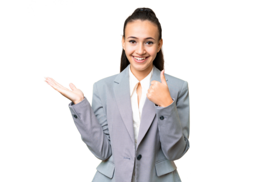 Young Arabian woman over isolated chroma key background holding copyspace imaginary on the palm to insert an ad and with thumbs up