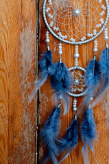 Dreamcatcher on wooden background. Indian shaman lucky amulet
