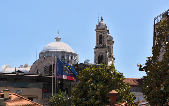 Aya Triada Rum Ortodoks Kilisesi of 1880 in the center of Istanbul in the foreground develops a European flag