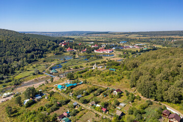 Fototapeta na wymiar South Urals, General view of the valley of Krasnousolsk resort: territory of sanatorium, and Church of the Tabyn icon of the mother of God. Aerial view.