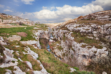 Fototapeta na wymiar Gravina in Puglia, Bari, Italy: landscape of the countryside near the town with the rock-cut creek bed