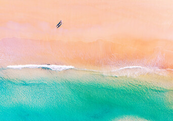 Aerial view of amazing beach with honeymoon couple walking on beach in morning light close to turquoise sea,Top view of summer beach landscape,Holiday Travel and tour concept - obrazy, fototapety, plakaty