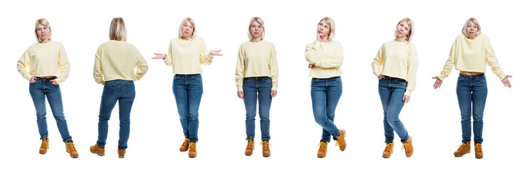 A young woman in jeans, a yellow sweater and boots is standing. Pretty blonde with freckles. Full...