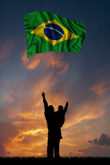 Father with son and the flag of Brazil