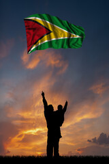 Father with son and the flag of Guyana