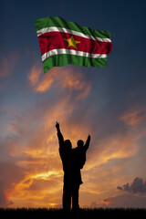 Father with son and the flag of Suriname