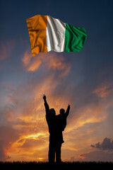 Father with son and the flag of Cote dIvoire