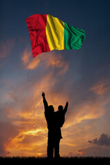 Father with son and the flag of Guinea