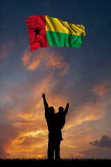Father with son and the flag of Guinea Bissau