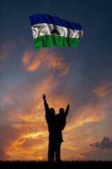 Father with son and the flag of Lesotho