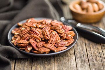 Peeled pecan nuts on plate.