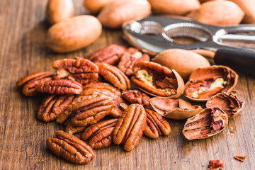 Peeled pecan nuts on wooden table.