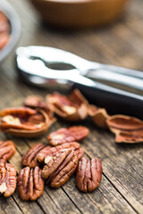 Peeled pecan nuts on wooden table.