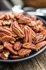 Peeled pecan nuts on plate.